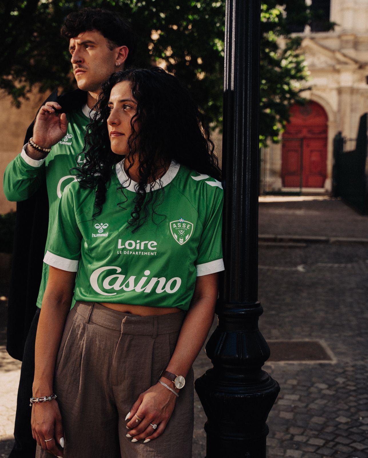 Couple portrait in the street, wearing the ASSE x Hummel jersey