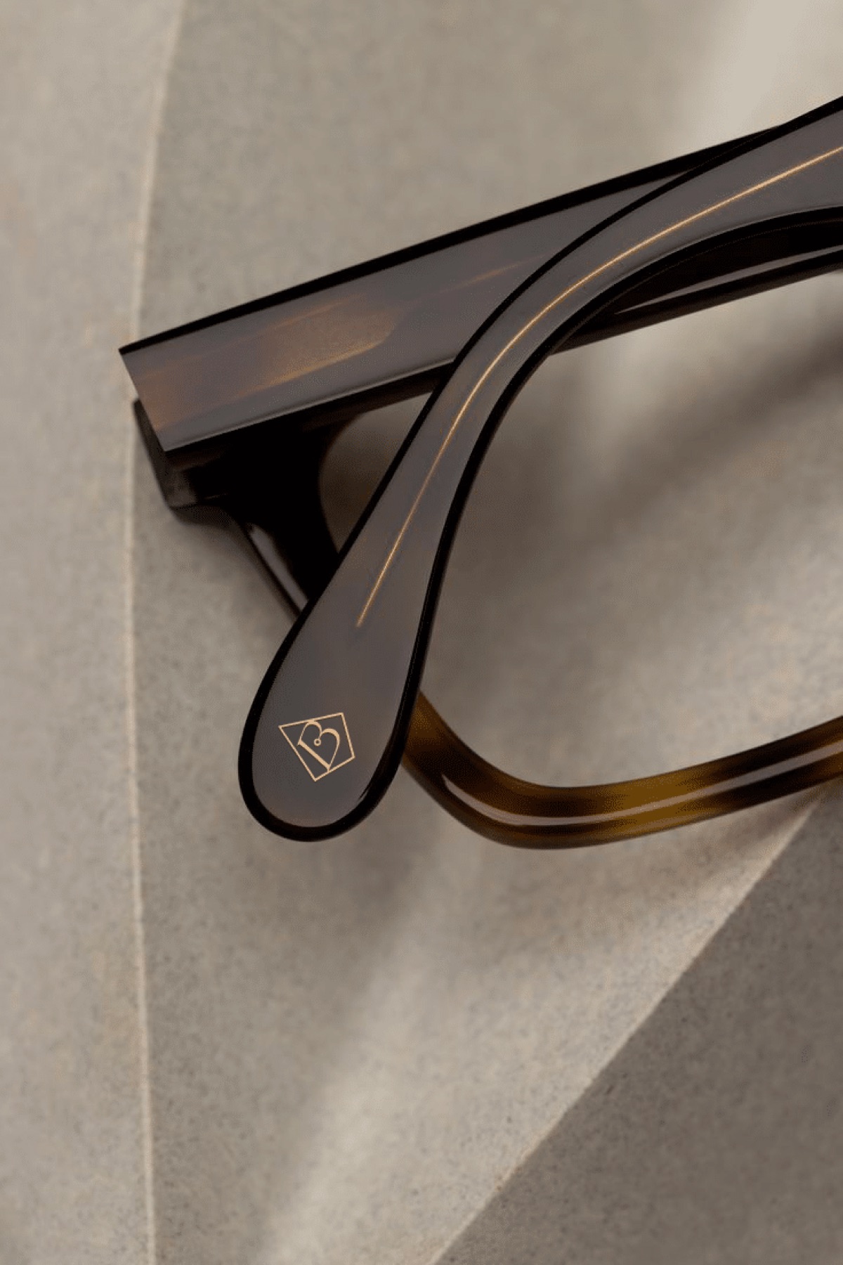 Detail of a glasses temple and its engraved logo