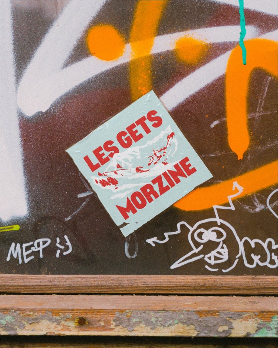 Destination sticker on a street-art wall