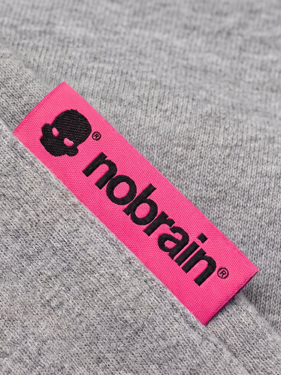Nobrain textile label sewn onto a grey garment